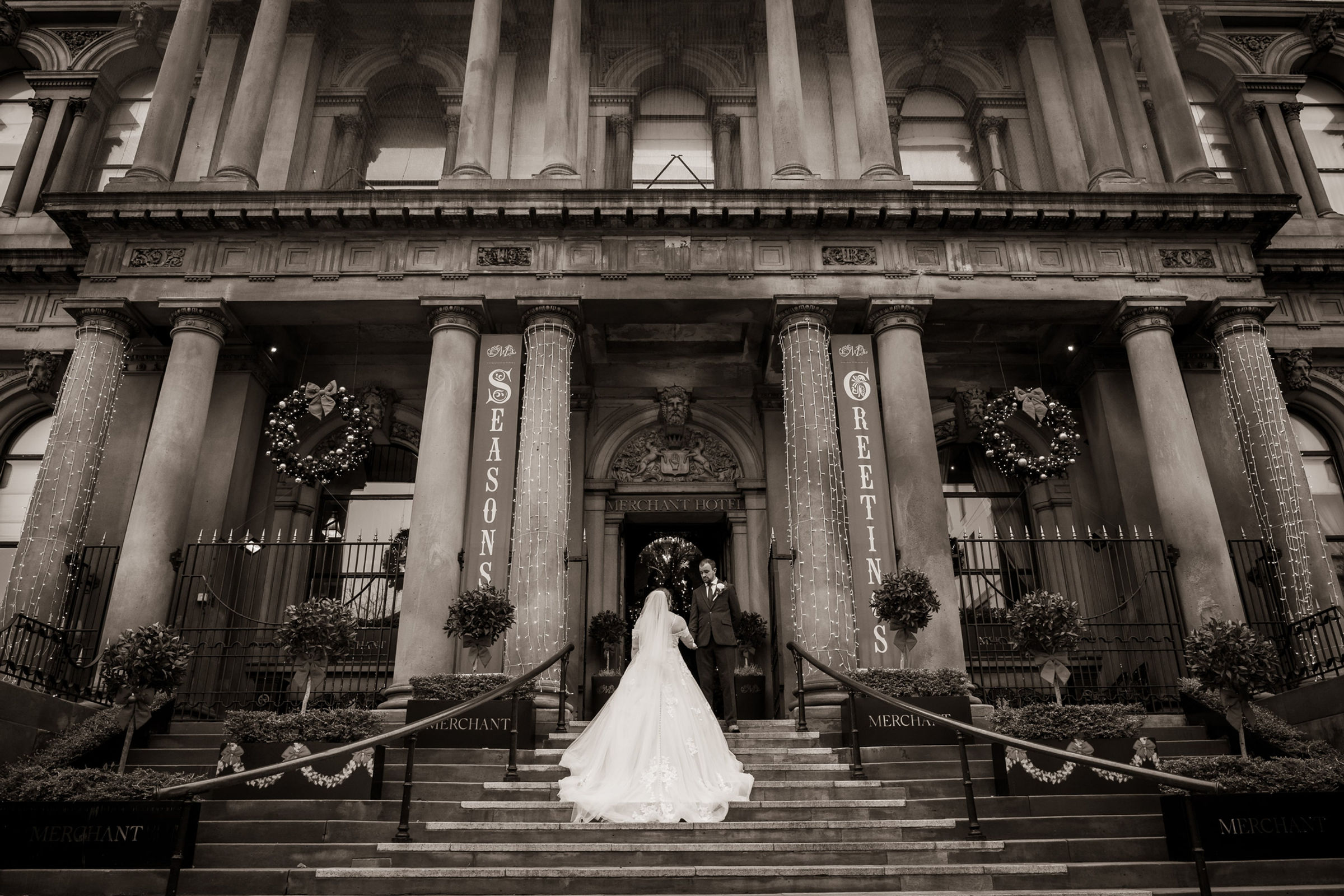 A newly married couple on the steps of The Merchant Hotel